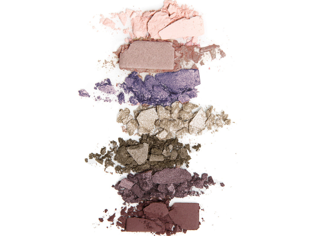 Multiple color powder makeups laying on a white background.