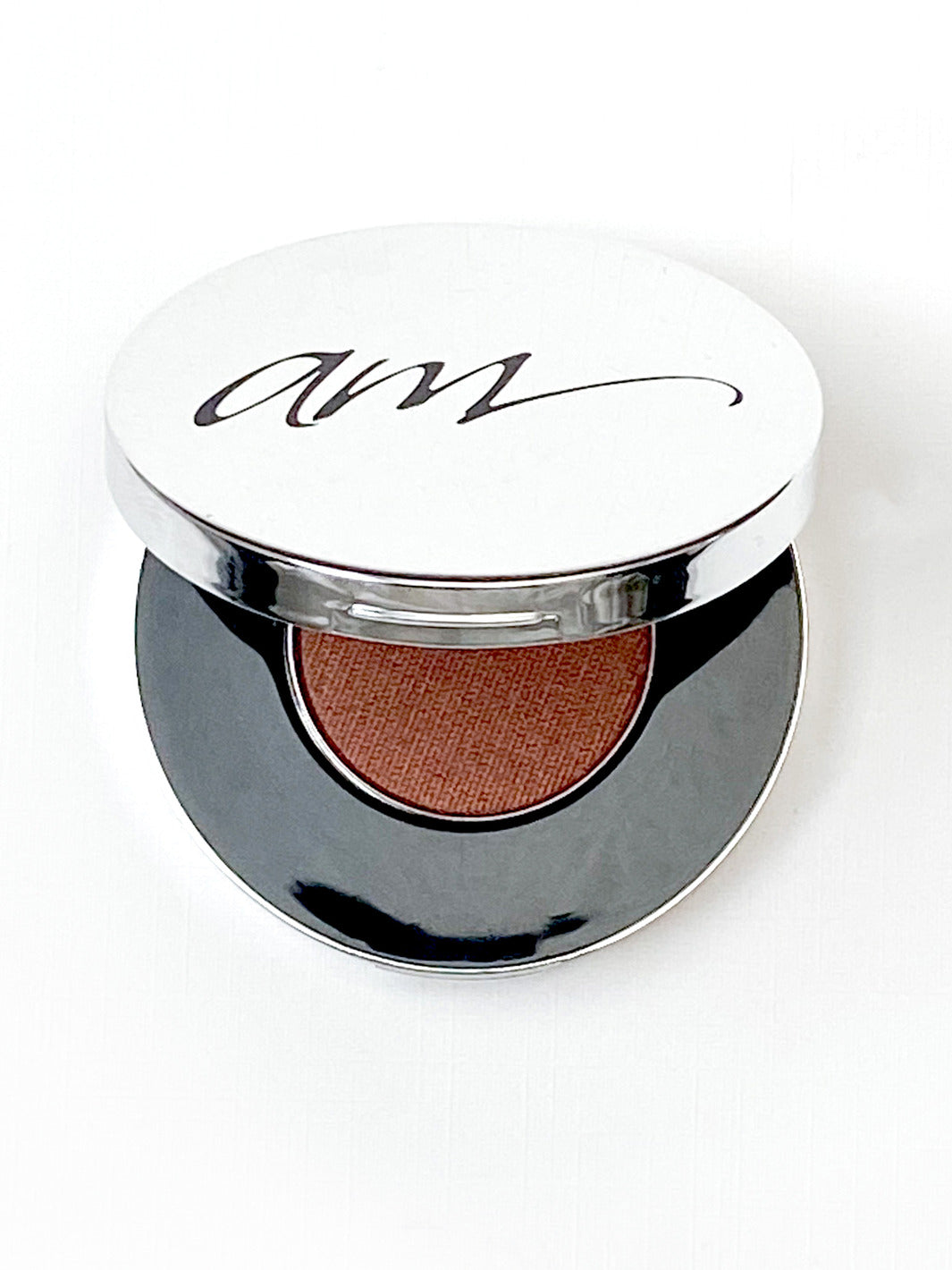The top view of an advanced mineral makeup compact with powder contents in the color of 'bronzed chocolate' and the lid half way off. #colour_bronzed-chocolate