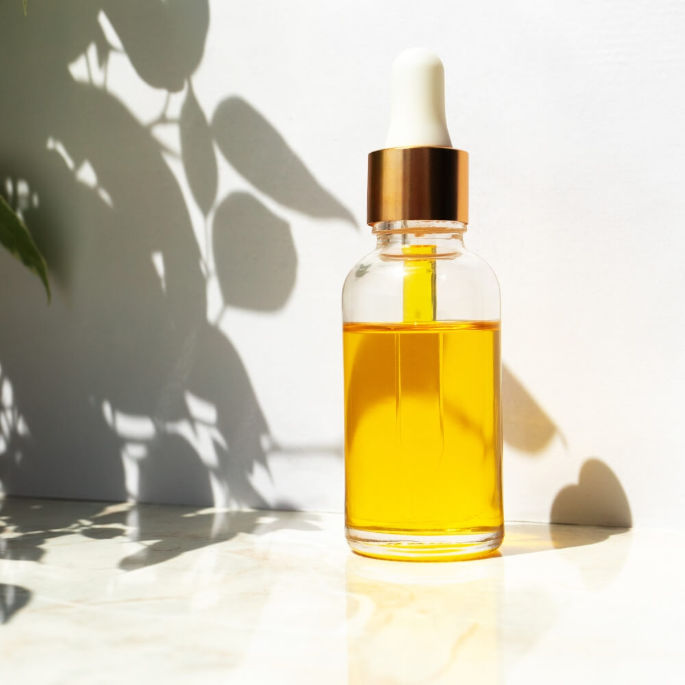 A small bottle with yellow liquid in it.
