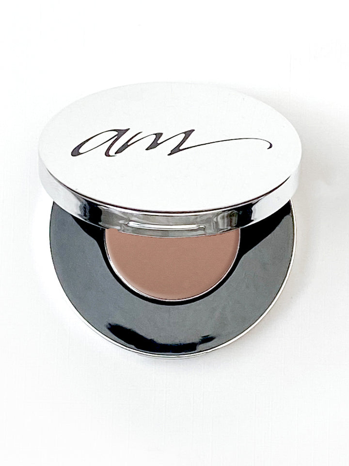 The top view of an advanced mineral makeup compact with powder contents in the color of 'Golden Sand' and the lid half way off. #colour_golden-sand