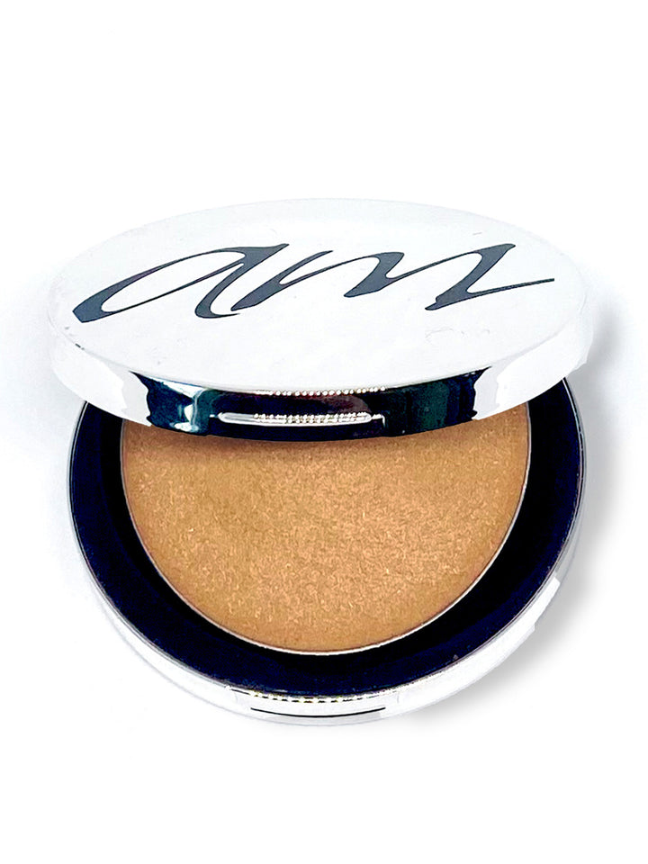 The top view of an advanced mineral makeup product with in the color of 'lumigold' with the lid half way off. #colour_gold