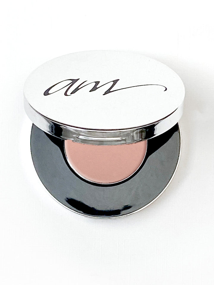 The top view of an advanced mineral makeup compact with powder contents in the color of 'pink-champagne' and the lid half way off. #colour_pink-champagne