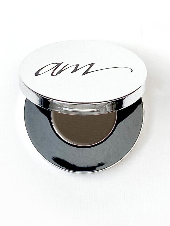 The top view of an advanced mineral makeup compact with powder contents in the color of 'slate' and the lid half way off. #colour_slate