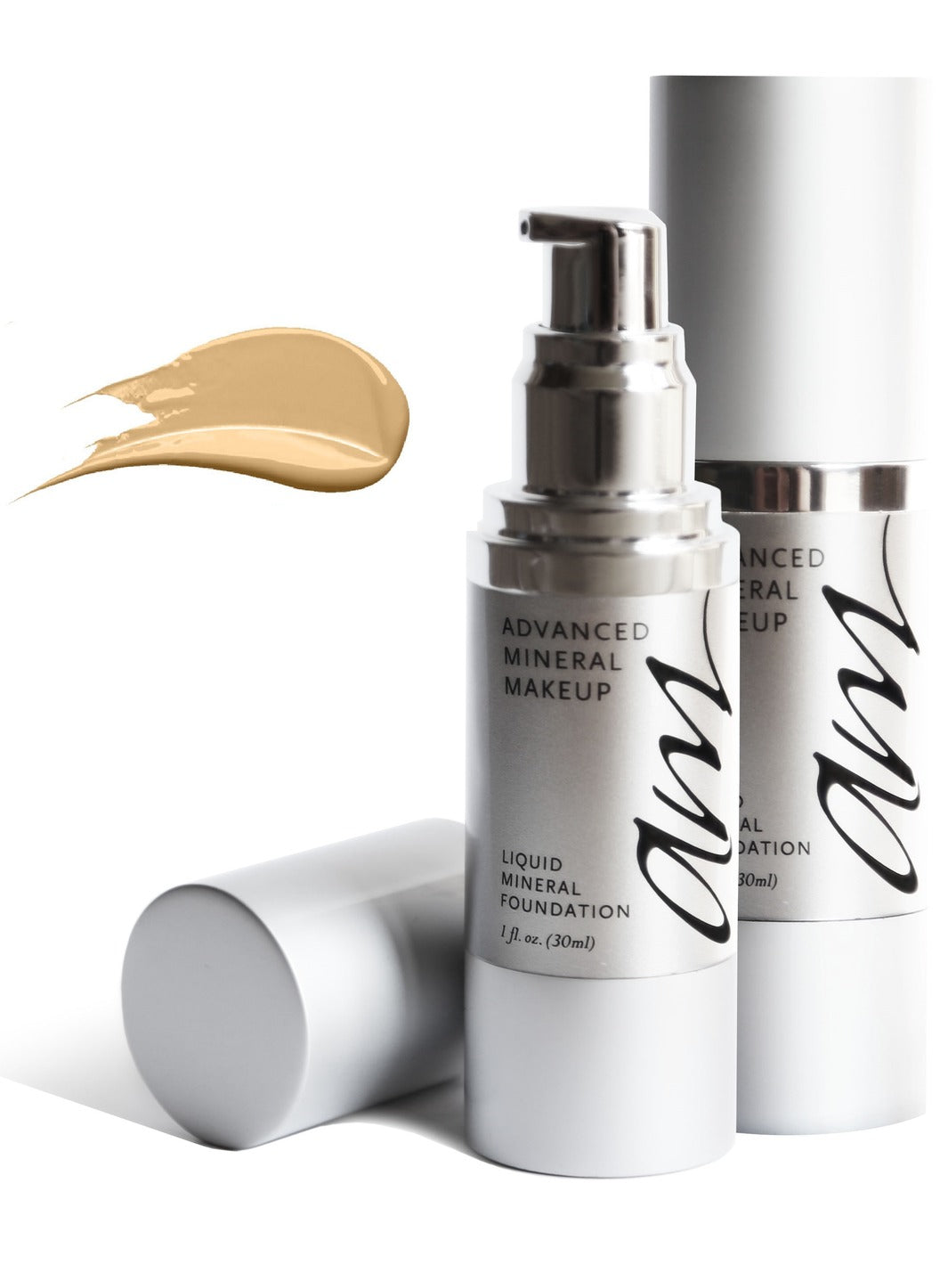 Two miniature pump bottles of makeup called 'liquid mineral foundation' on a white background with a swatch paint smear showing the off white color of the product. #colour_cr-me-br-l-e