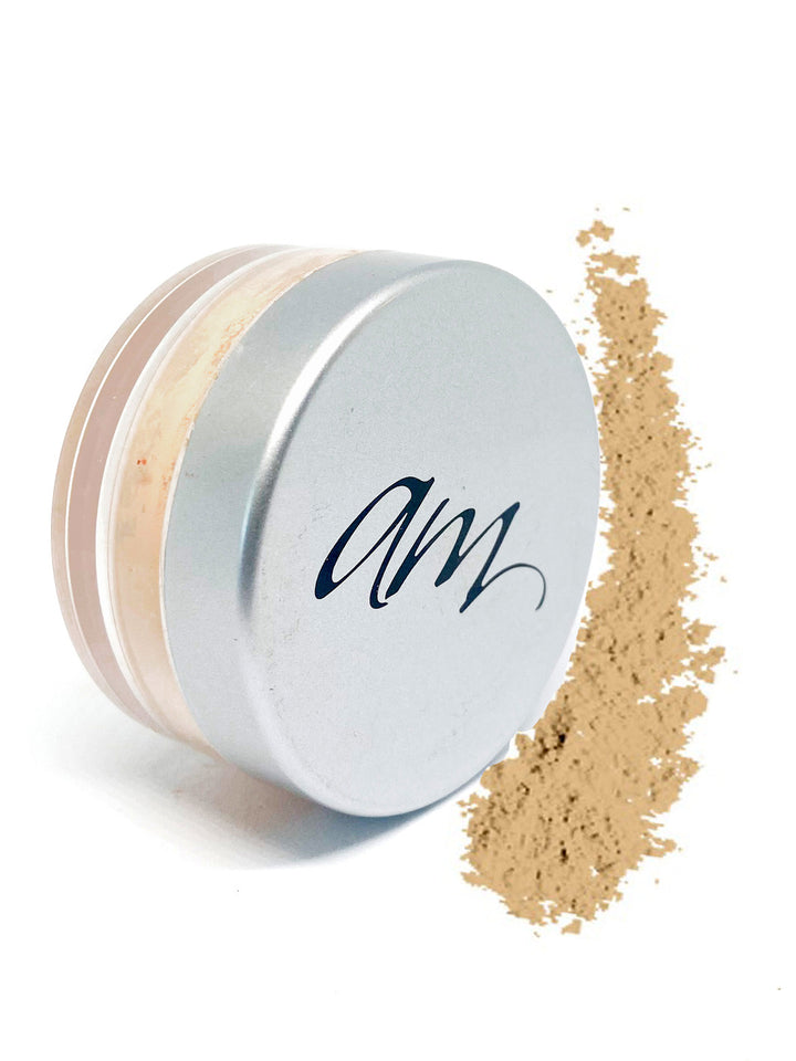 Advanced Mineral makeup loose foundation powder in a small cylinder with powder next to it on a white background. #colour_angelina